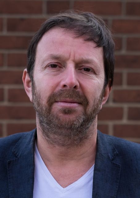 Close portrait with beard, navy jacket