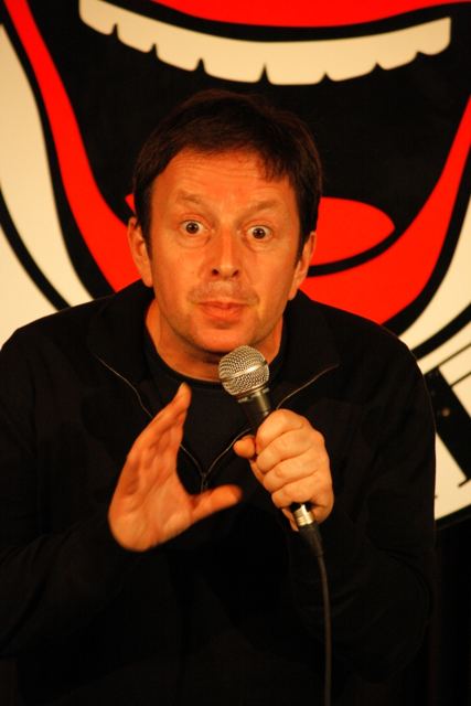 Close-up holding the microphone, eyebrows raised